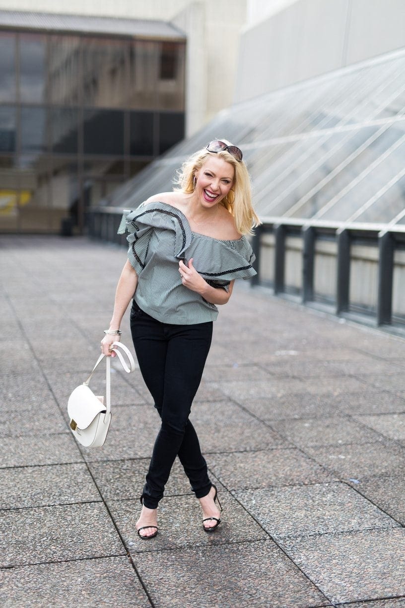 Black and white outfit. Black jeans and off the shoulder top stripe.