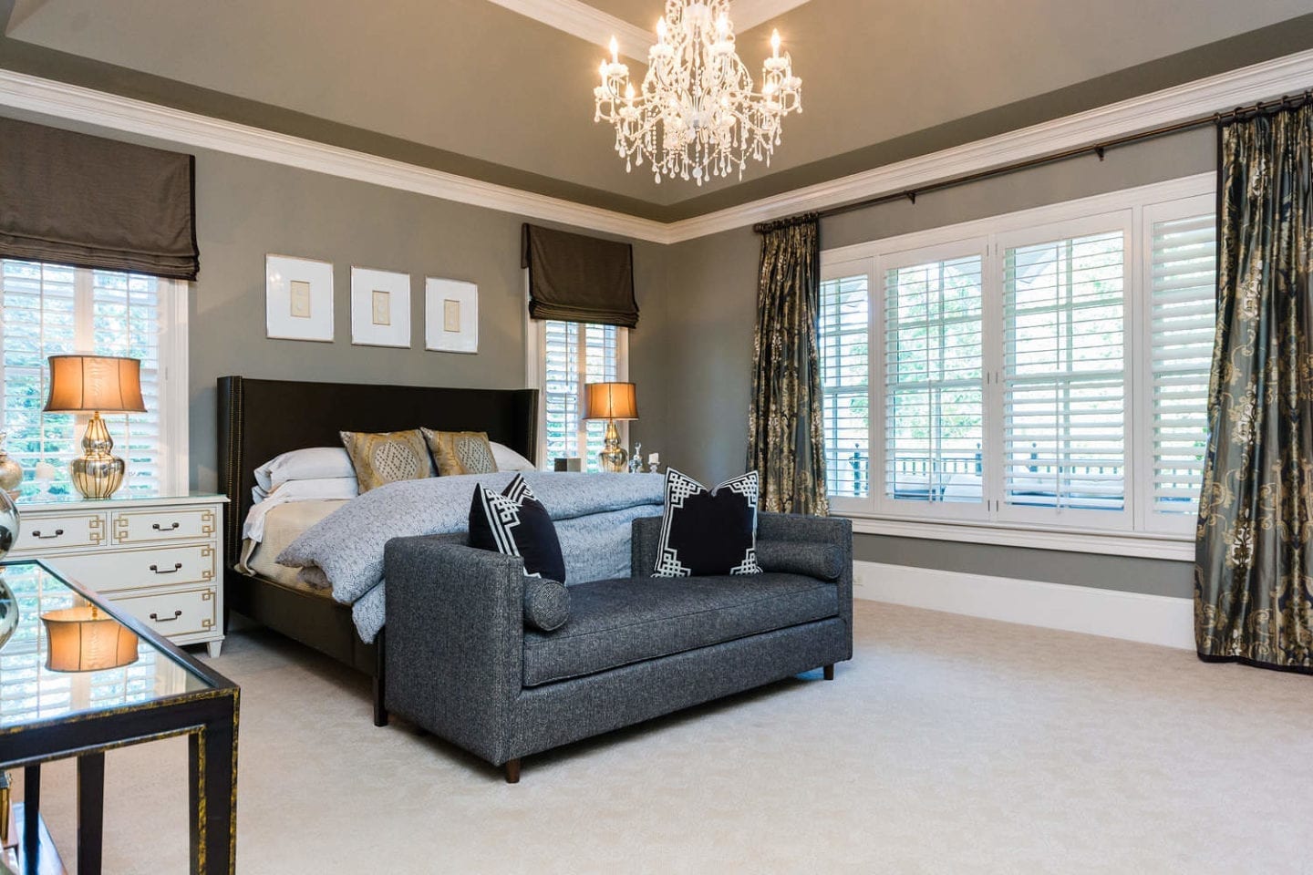 Gray Master Bedroom. How to decorate your house in gray. White chandelier and gray bench in front of Brown Silk bed.
