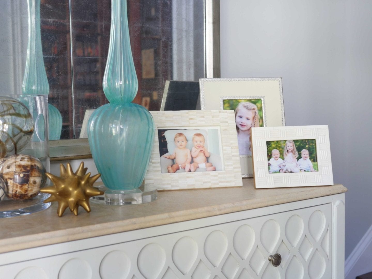 Foyer Entry Decor with ivory picture frames.