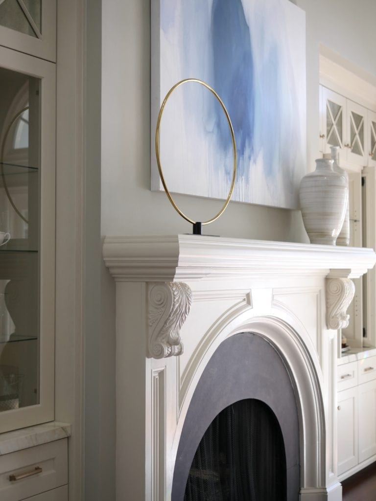 White mantel decor. Simple mantel decor and blue paint colors.