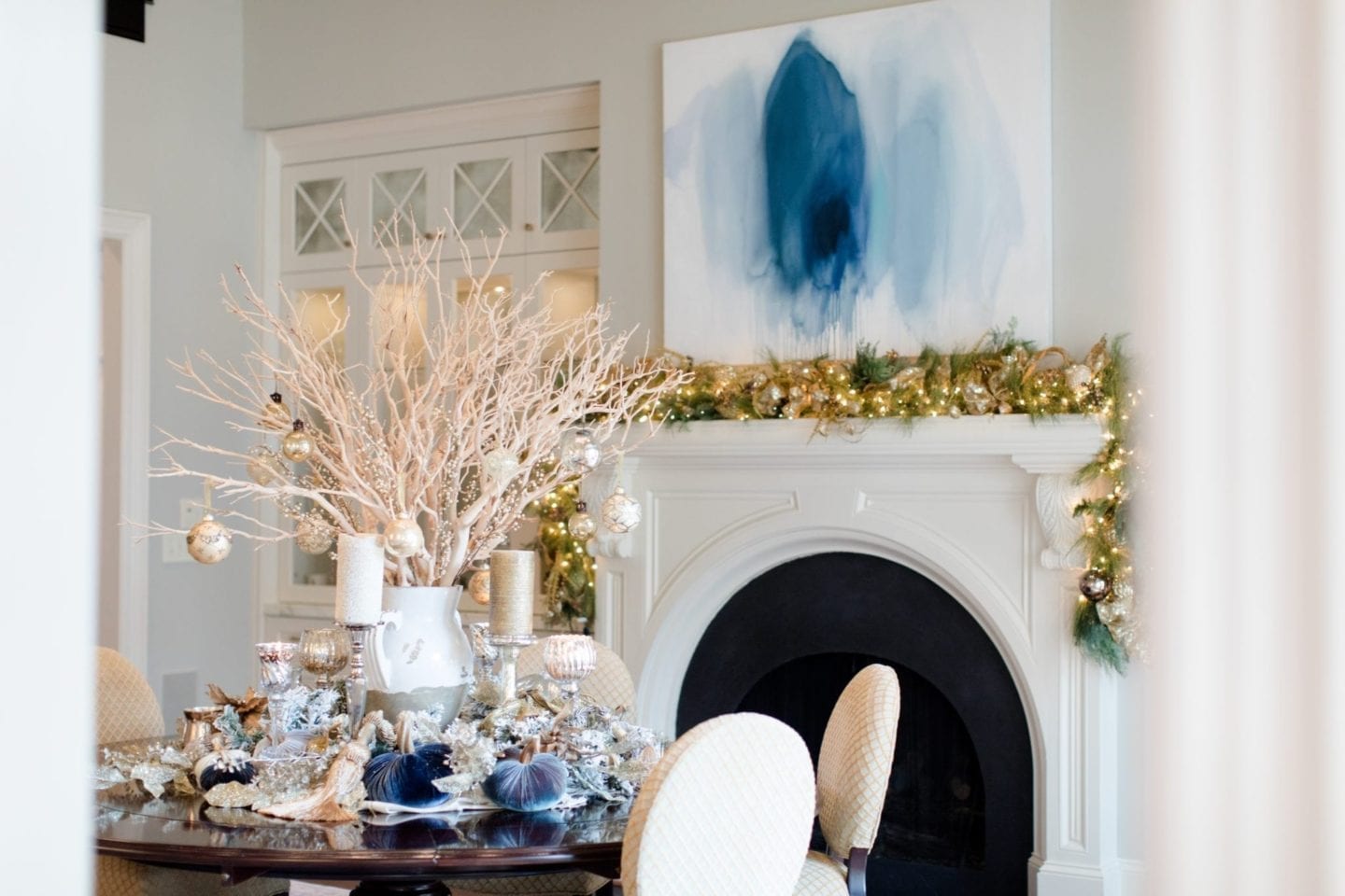 Dining Room with gold garland and Christmas decorations on dining room table with velvet pumpkins from bluegraygal in centerpiece.