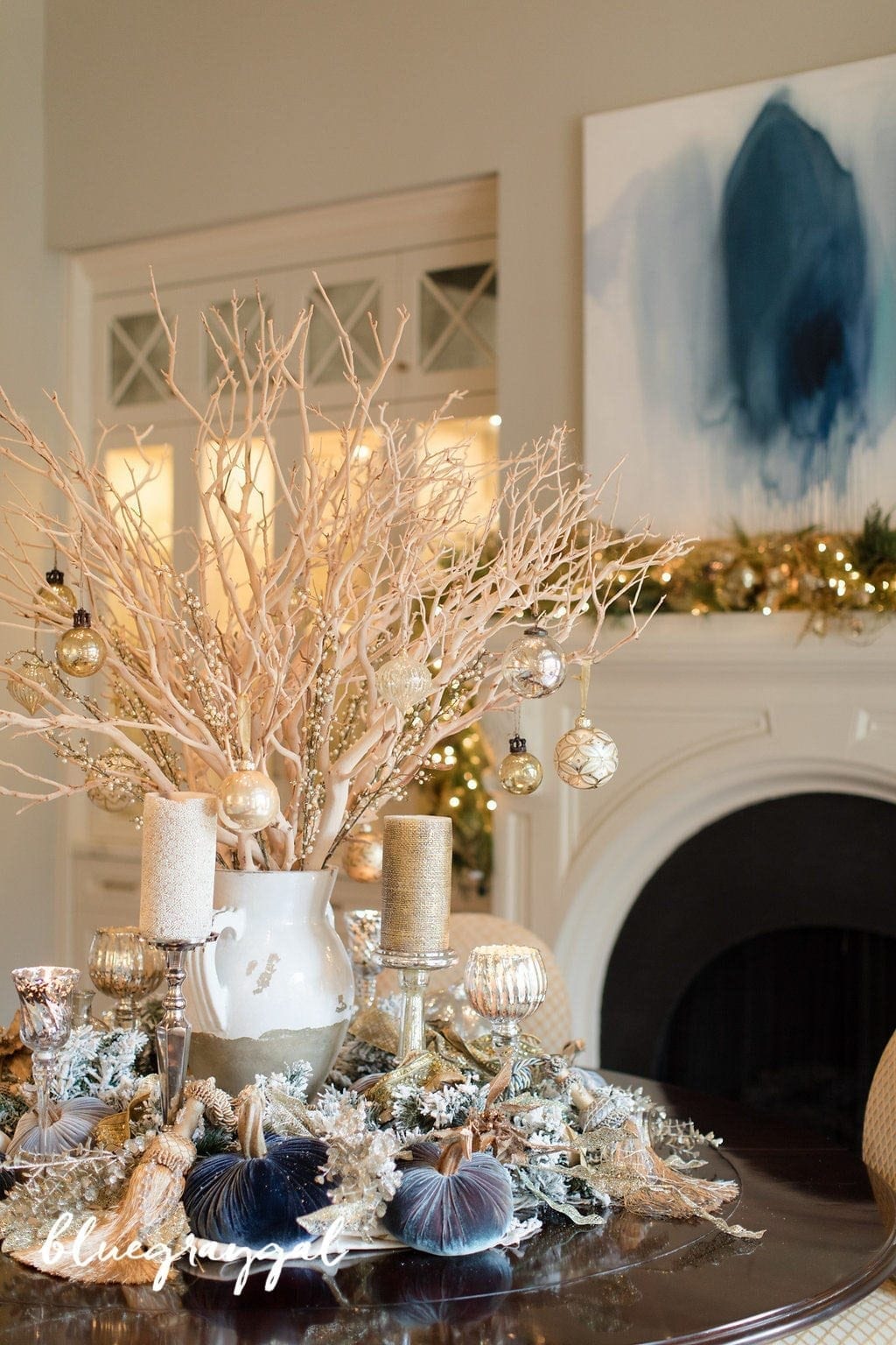 Holiday Centerpiece Decor with manzanita branches and a tuscan urn on a round dining room table