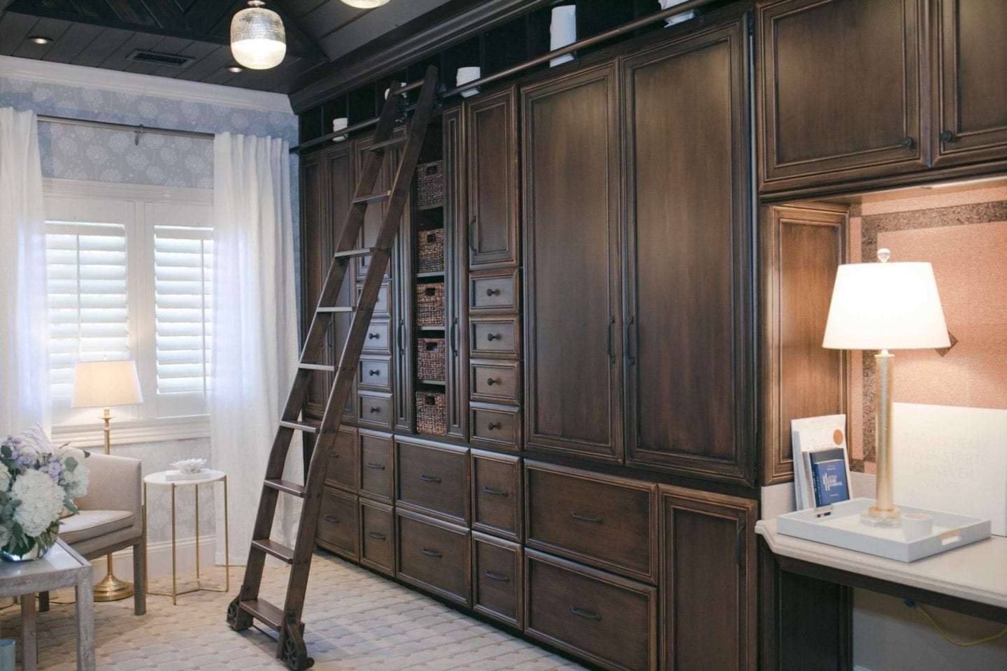 peel and stick wallpaper in dark office with dark wood built ins and library ladder