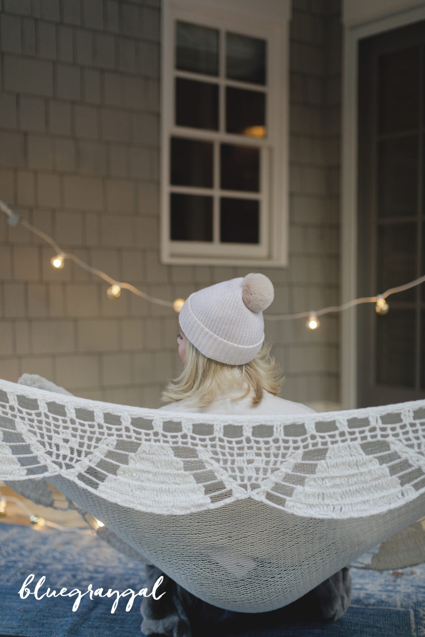 kelly page in pink pom pom cashmere beanie in woven hammock by winter lights 