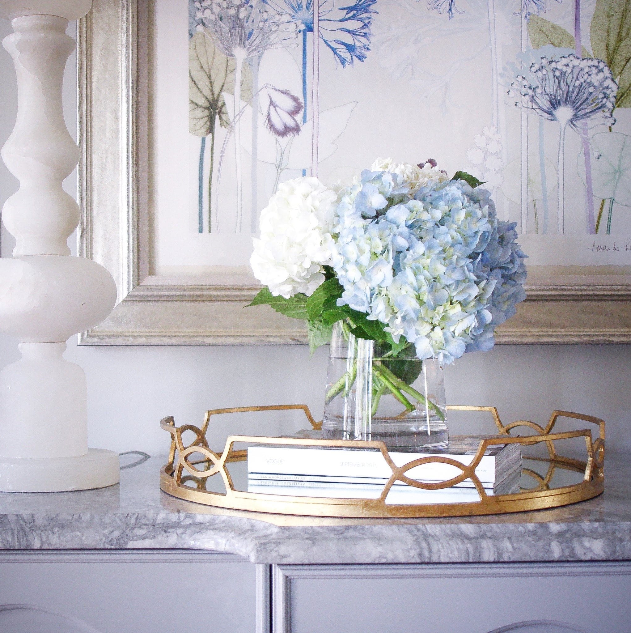 Simple hydrangea arrangement for buffet tables Gold tray and marble white lamps to add light.