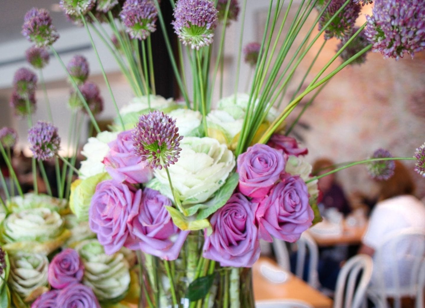 Lavender floral arrangement made with fake allium and real touch lavender roses.