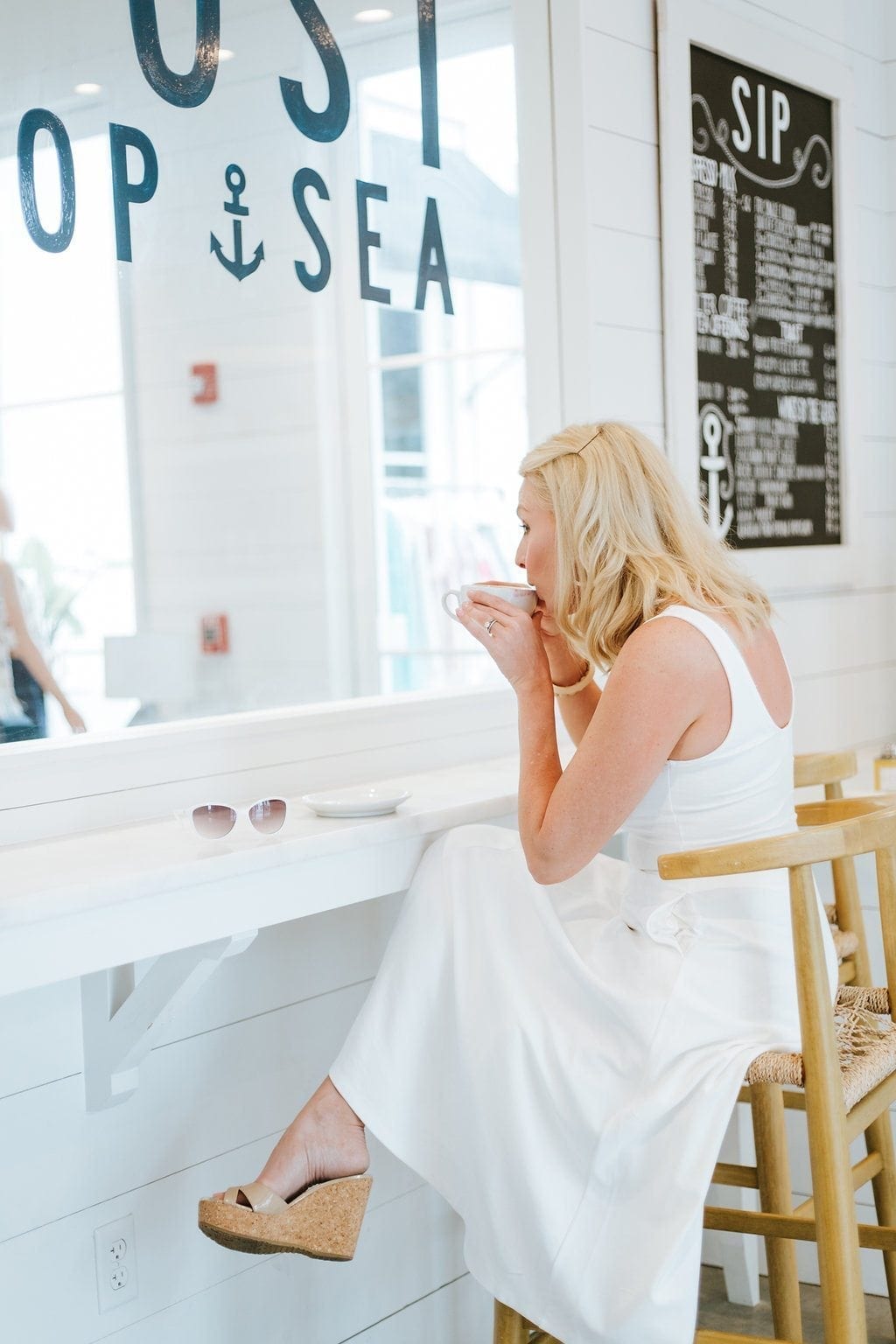 Rosemary Beach vacations. White dress in coffee shop. The Outpost in Rosemary Beach.