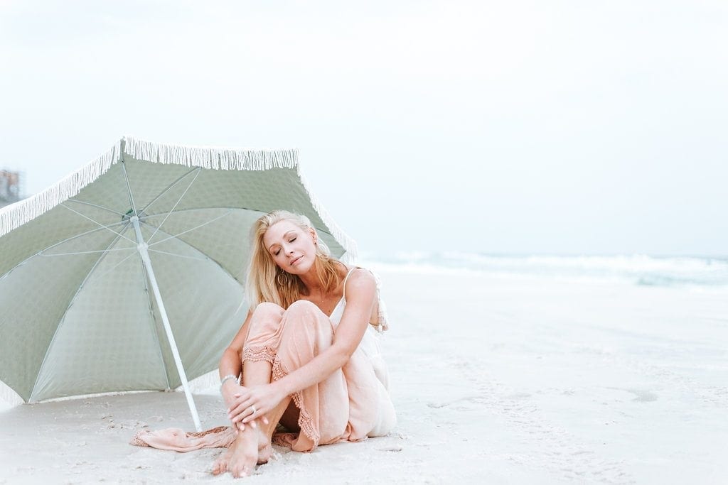 Social media and self esteem. What are you doing about your own depression? Kelly Page in a light pink maxi dress on the beach.