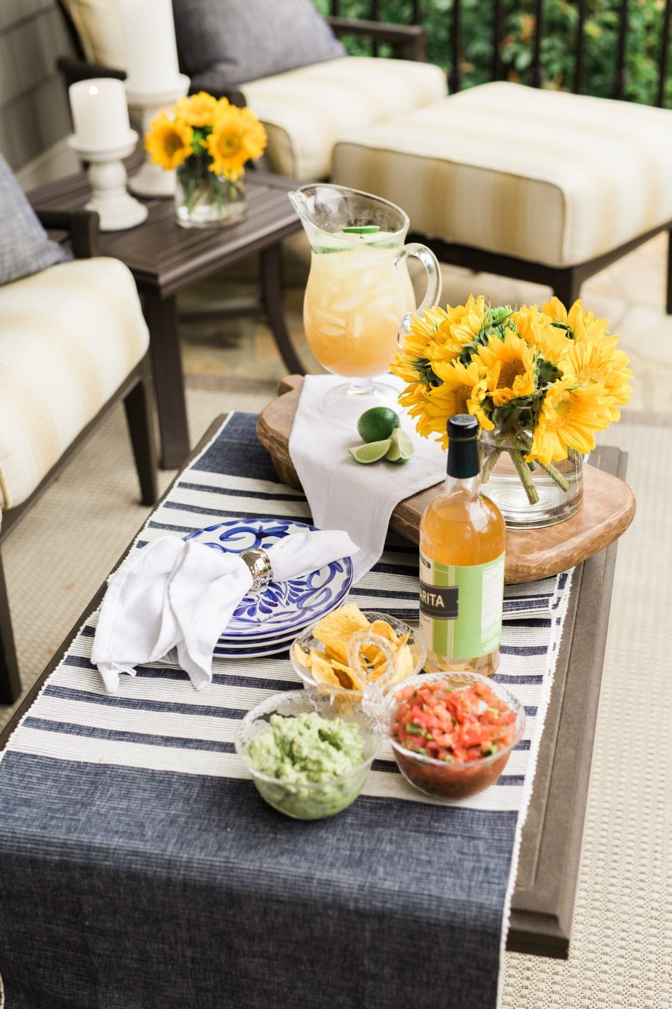 Fiesta party with blue and yellow. Yellow sunflowers and patio furniture filled with summer party fun!