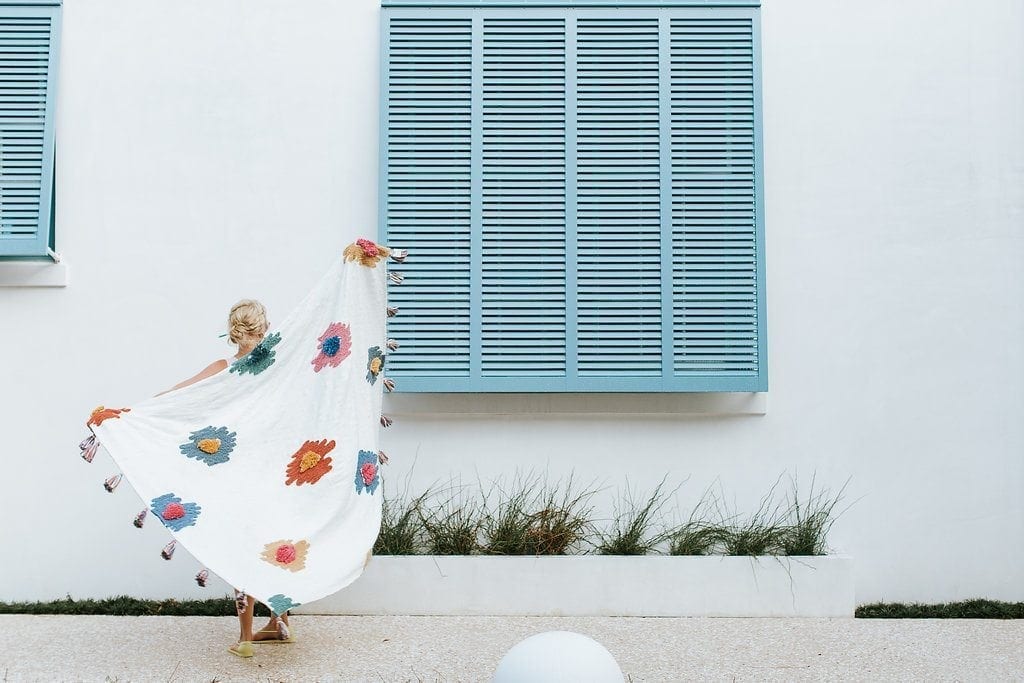 Atlanta blogger Kelly Page. Blue shutters and Anthropologie throw blanket in Alys Beach, Florida. This post includes my top Anthropologie home picks, including the best of the Anthropologie Mirror and Anthropologie Wallpaper collection items.