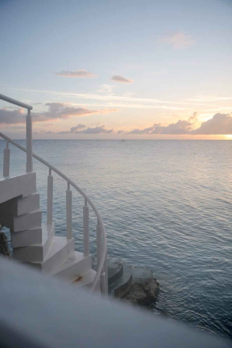 Four Seasons Anguilla and Caribbean ocean at sunset.
