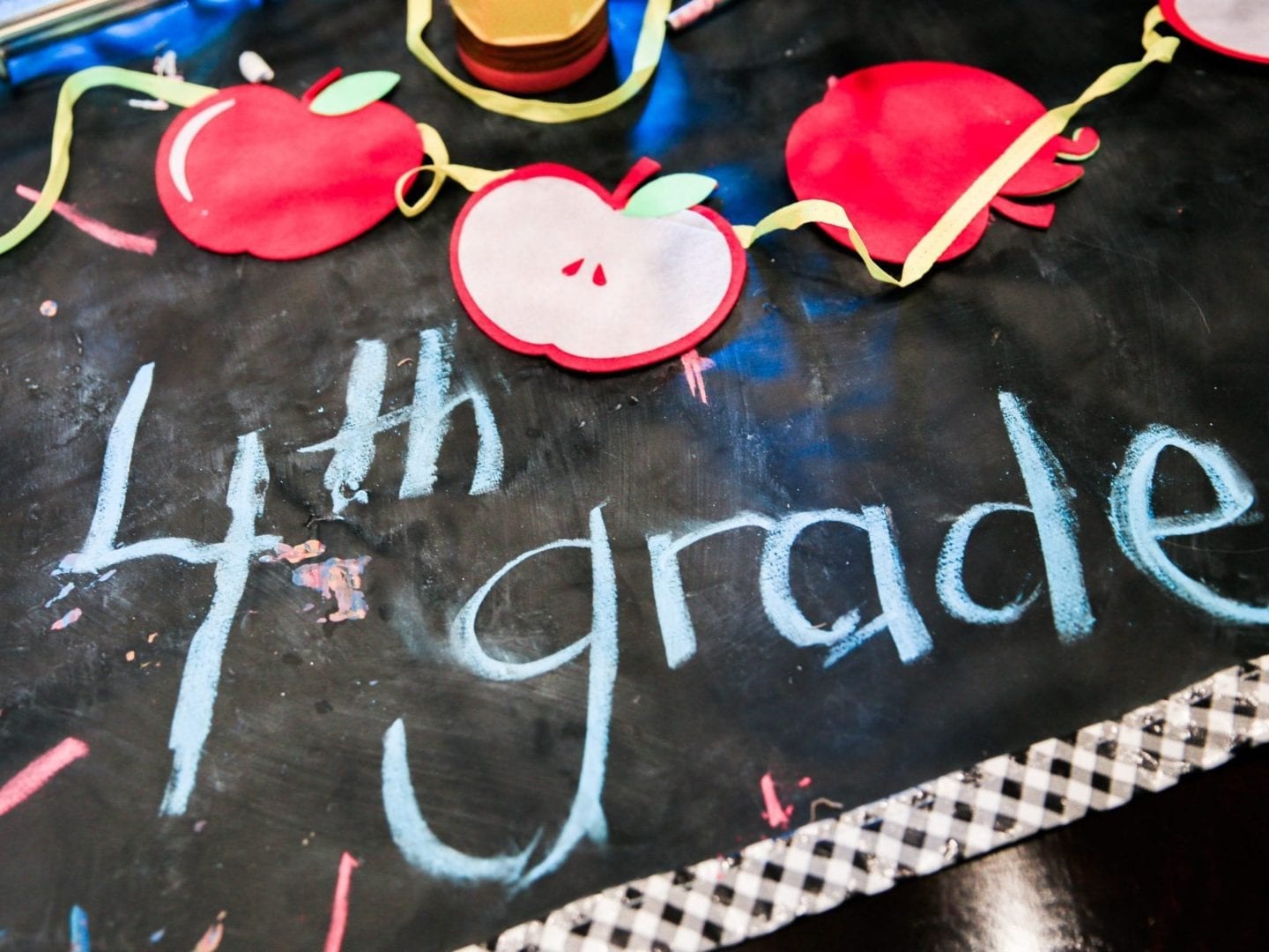 Chalboard mat with apple cut out garland for back to school decorations.