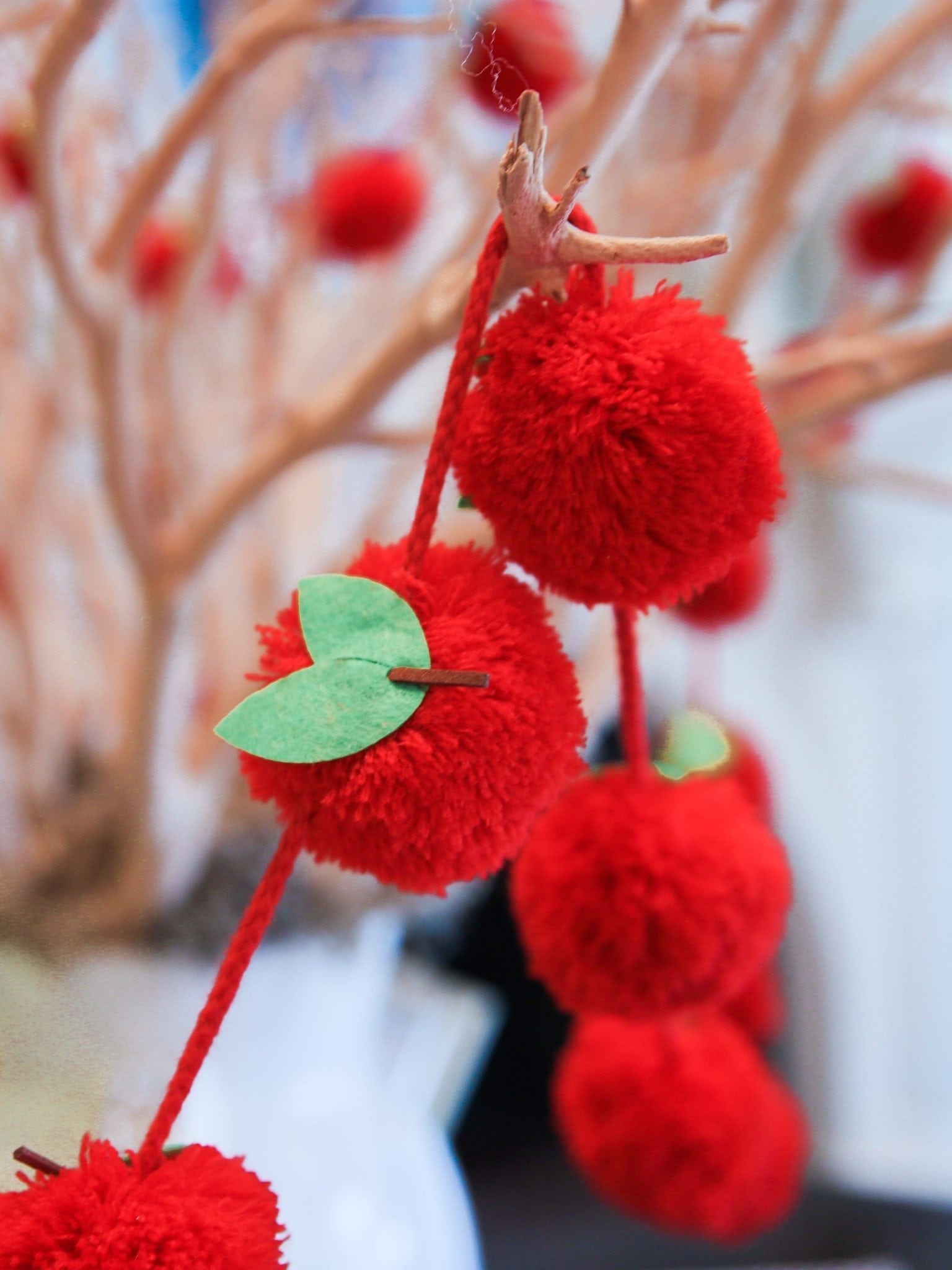 Red apple garland with apple pom poms