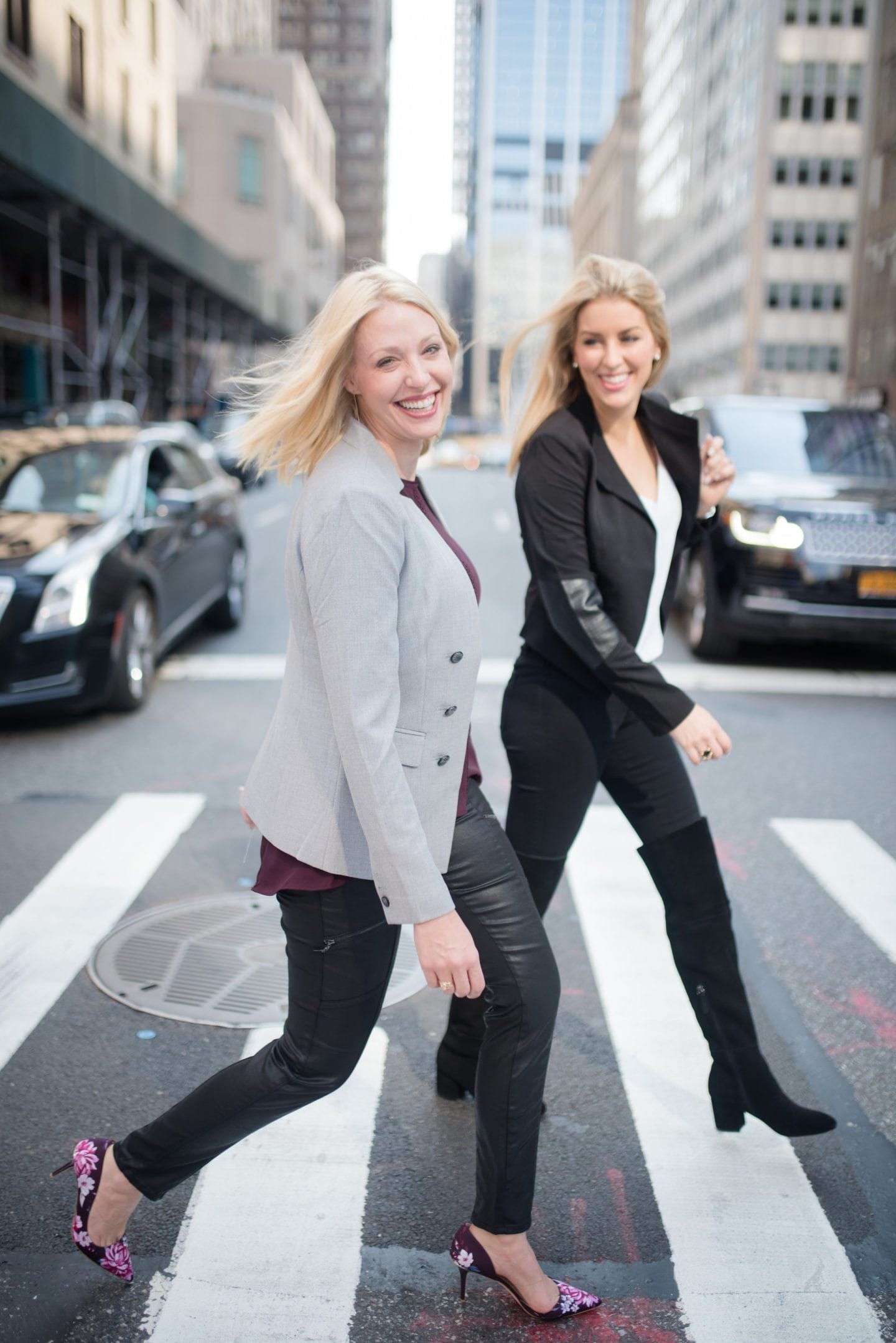 RewardStyle Like To Know It bloggers Jess Cathell and Kelly Page walking across the street in NYC with floral pumps and over the knee boots.