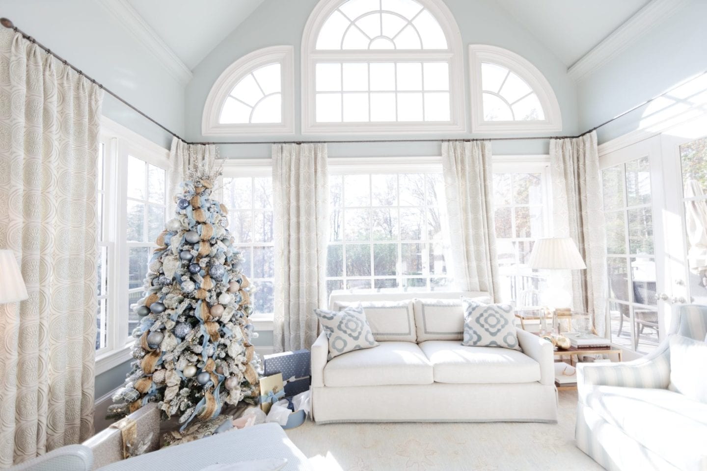 Living room designed in shades of light blue. Blue Christmas tree with Benjamin Moore Gray Wisp paint.