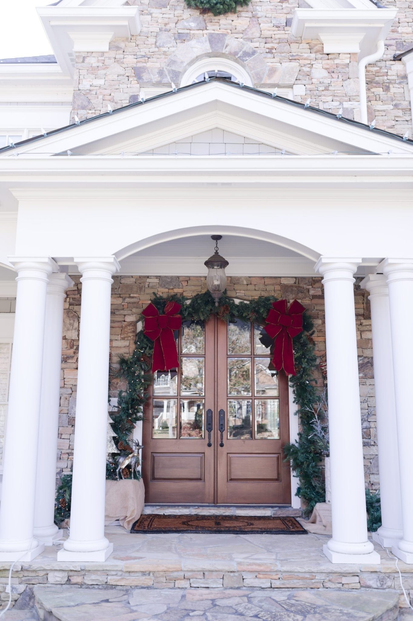 Christmas Decorations for the front door. Garland hung around door frame.