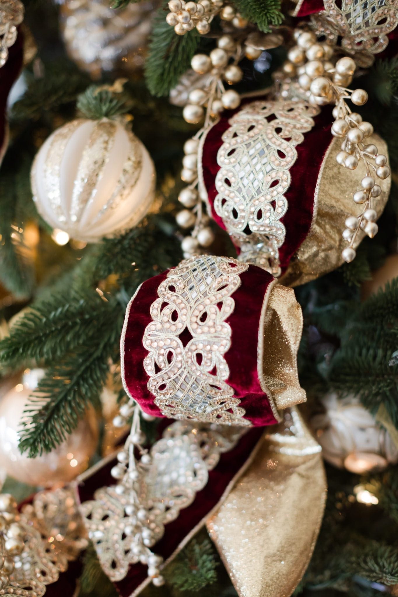 Maroon and gold Christmas ribbon with gold ornaments.