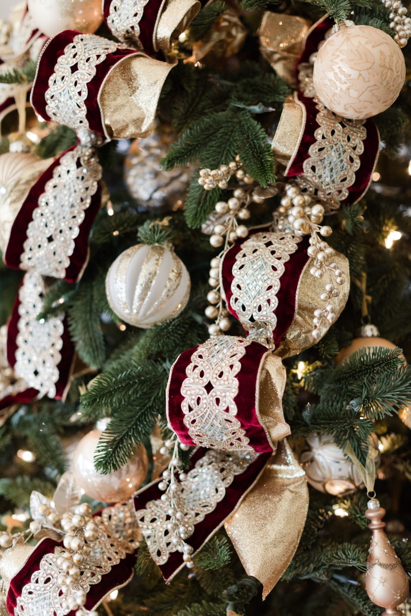 Ornament collection of gold and silver mixed in with ornate gold ribbon.