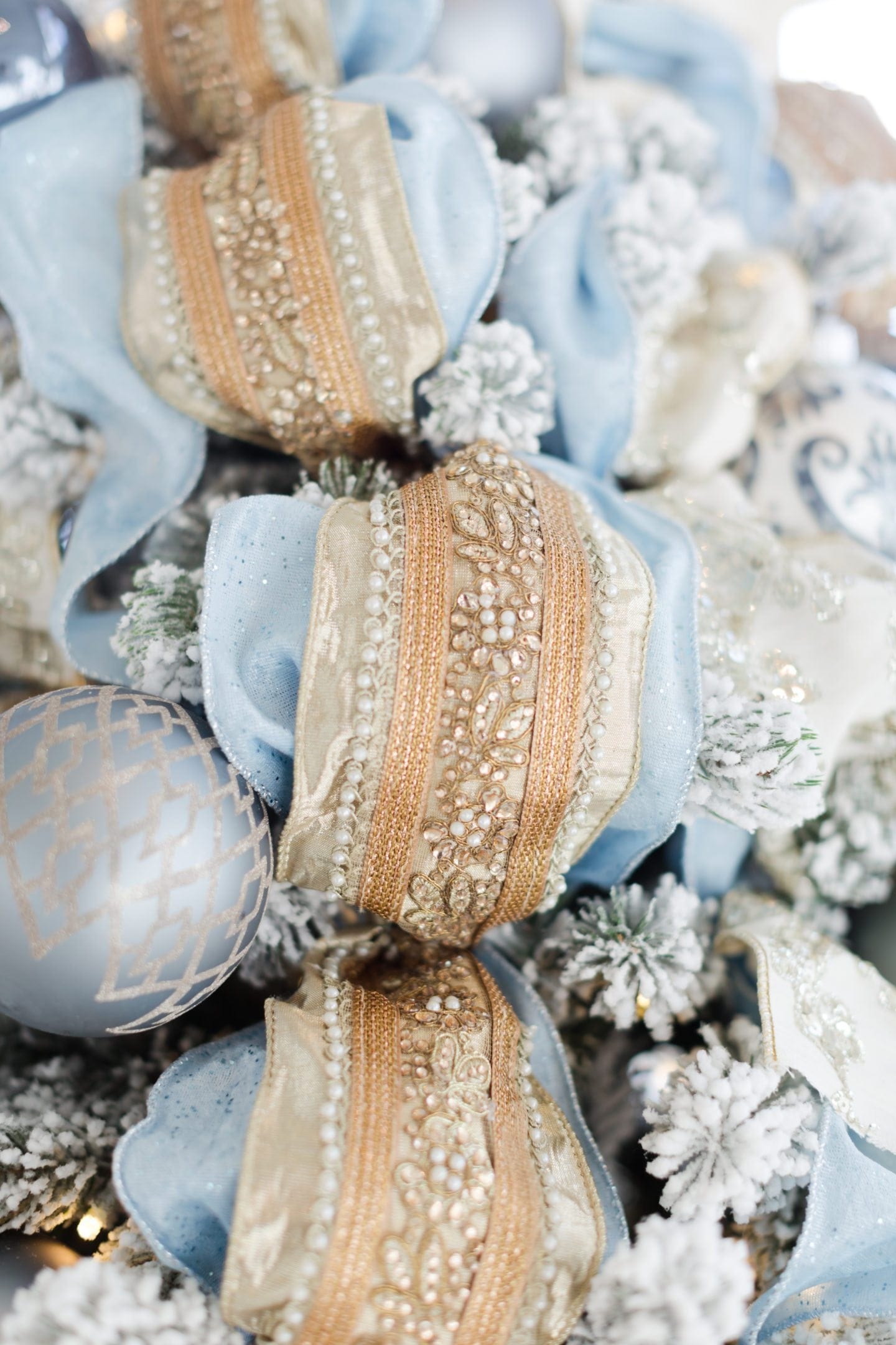 Gold embellished ribbon. Frontgate holiday collection ribbon and Frontgate ornaments with light blue Christmas tree decorations.