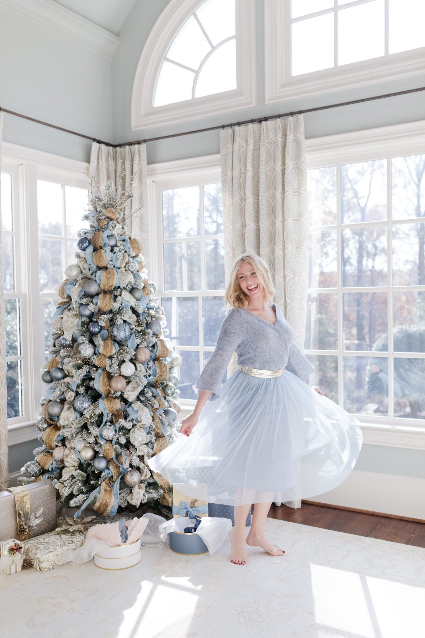 Light blue dress from Anthropologie. Anthropology dress with White House Black Market Obi belt. bluegraygal Kelly Page lifestyle blogger twirling by her blue Christmas tree.