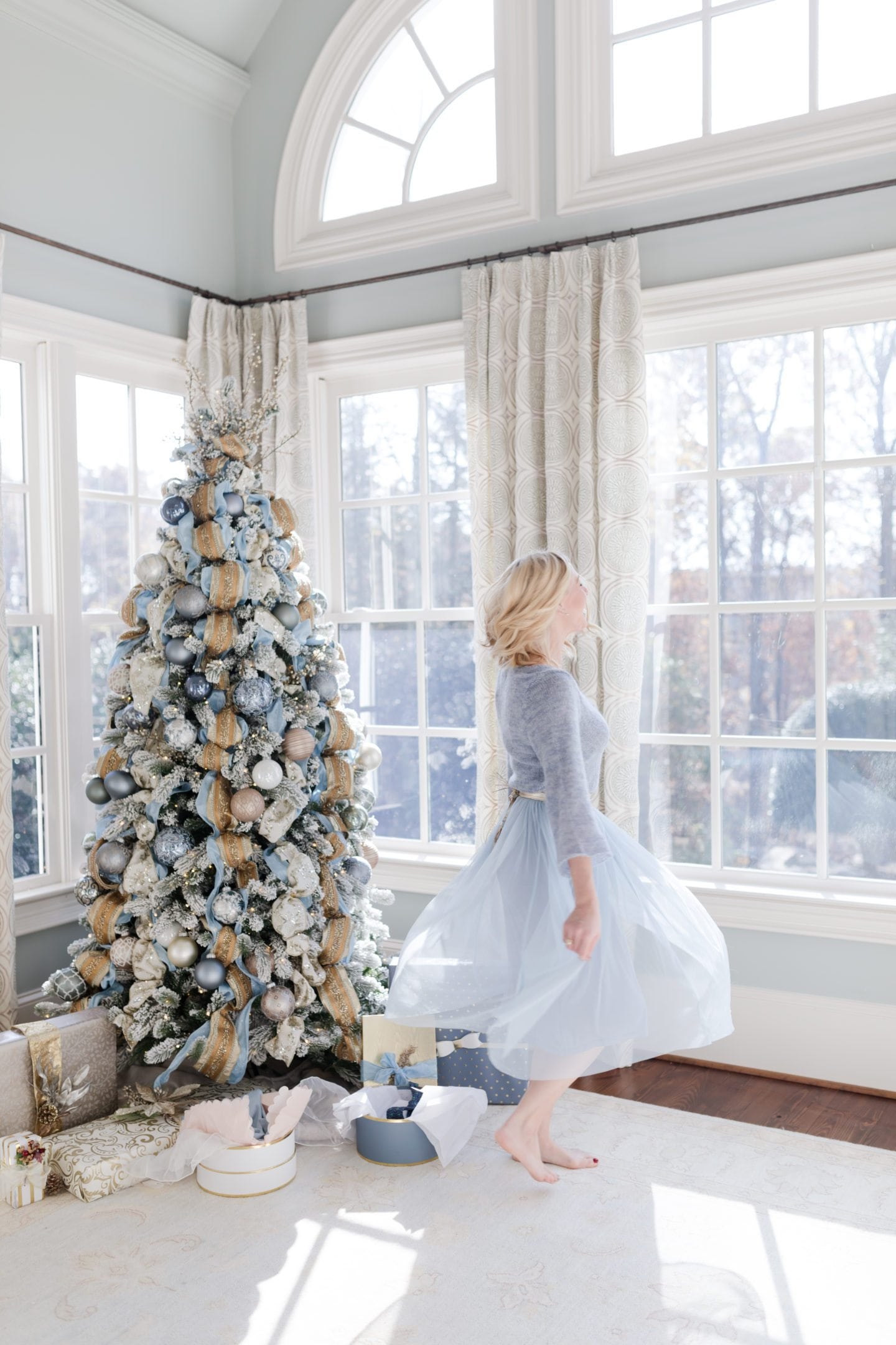 blue Christmas tree decor and light blue sweater and tulle dress.