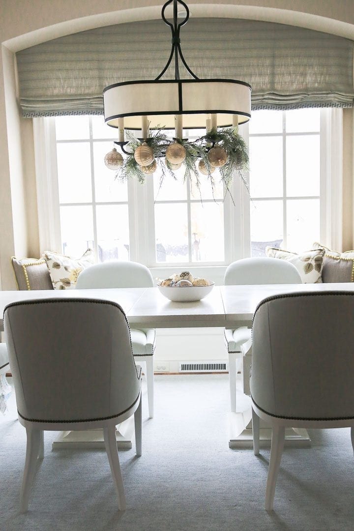 White kitchen table with light blue chairs with railheads.