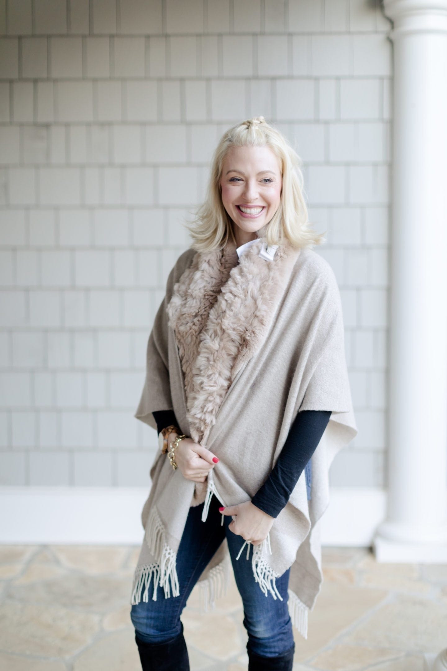 Rabbit fur scarf and fringe cashmere cape. Knee high black suede boots.