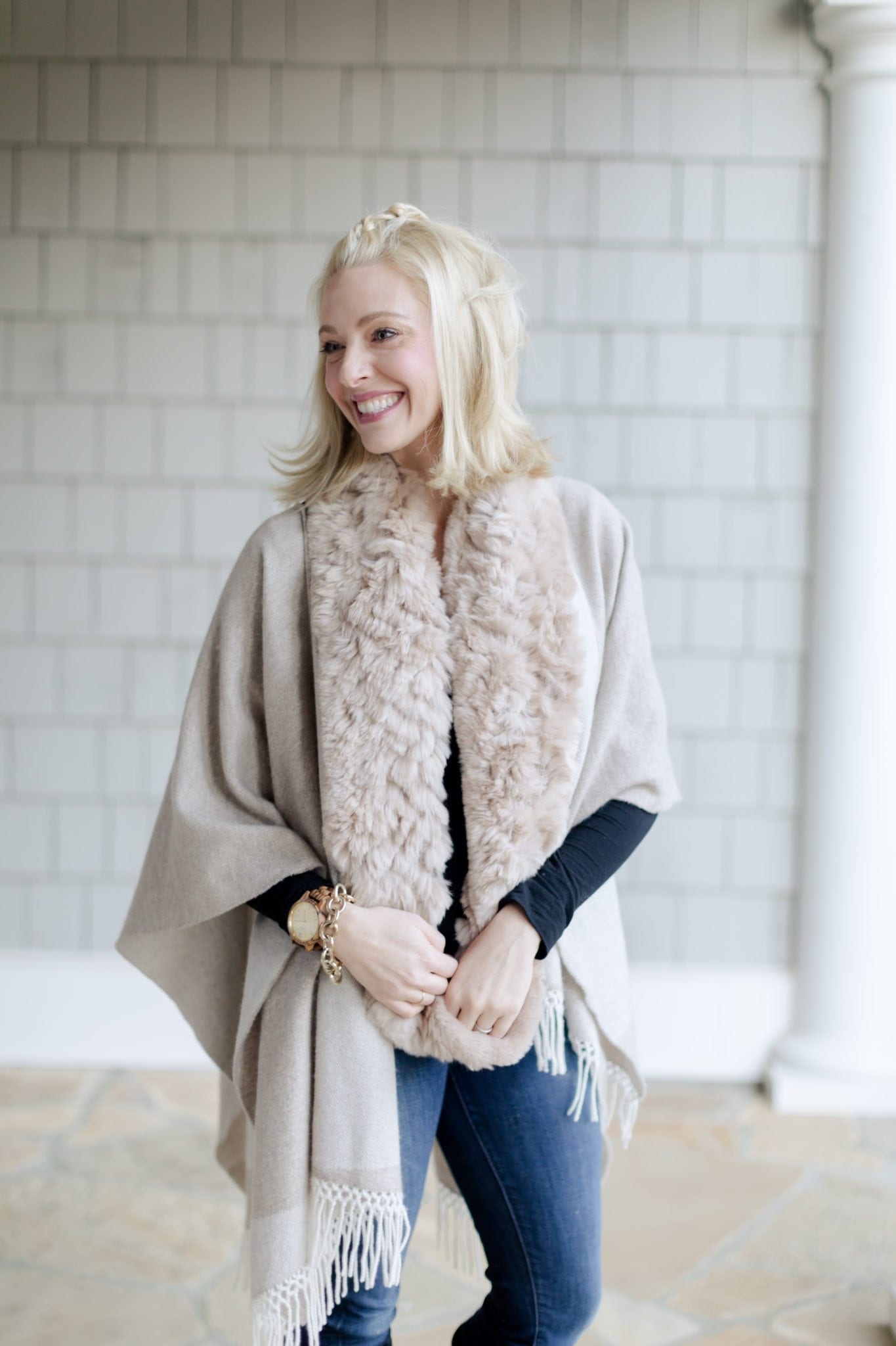 Stylish women's ponchos and capes are so versatile for all winter temps. This pretty outfit also has a real fur scarf paired with knee high suede boots!