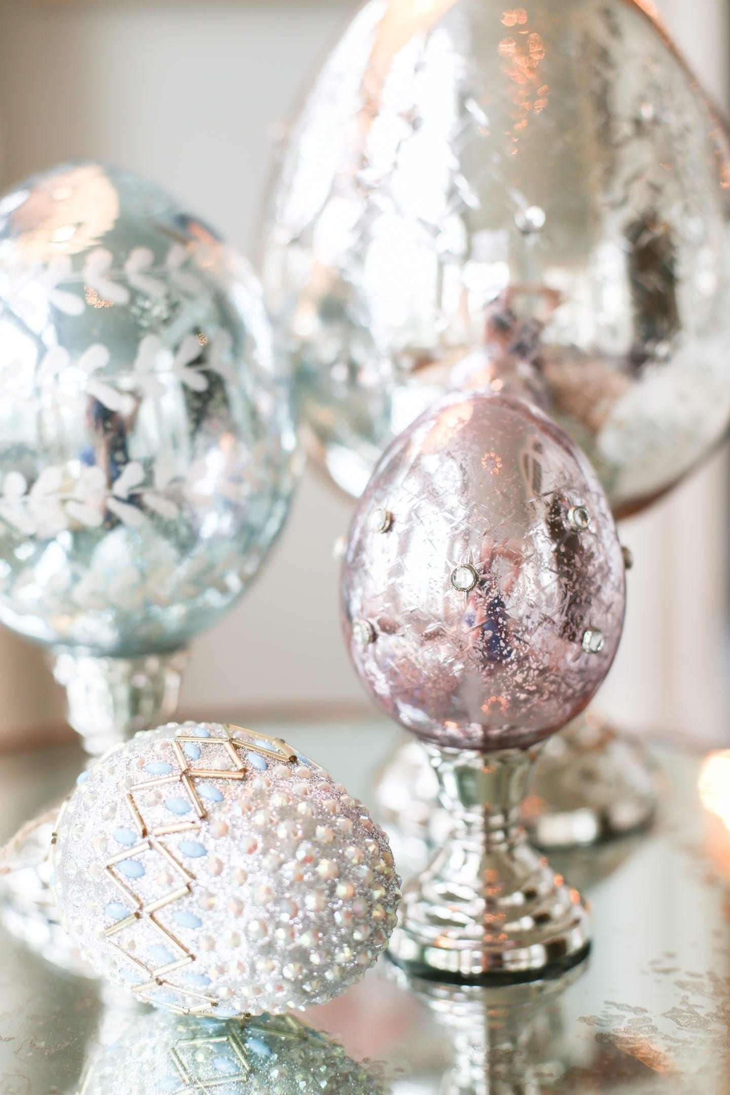 Mercury Glass decorative glass eggs. Eggs on stands for Easter decorating ideas in pastel pink and green.