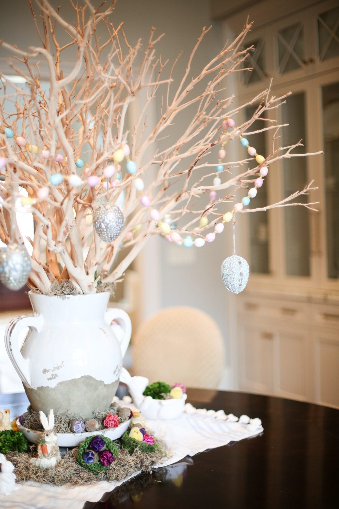 Egg garland and Pottery Barn Eggs on manzanita branch centerpiece with tuscan urn.