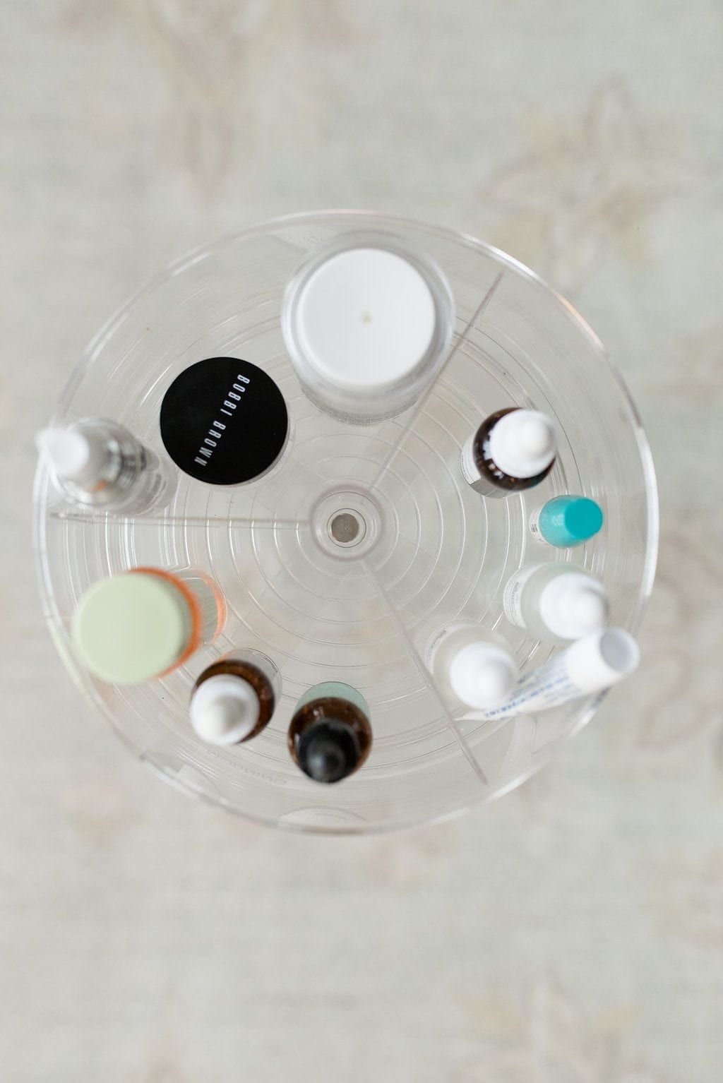 A lazy Susan filled with Daytime Moisturizers for women in their 40s recommended by lifestyle blogger Kelly Page for BlueGrayGal.
