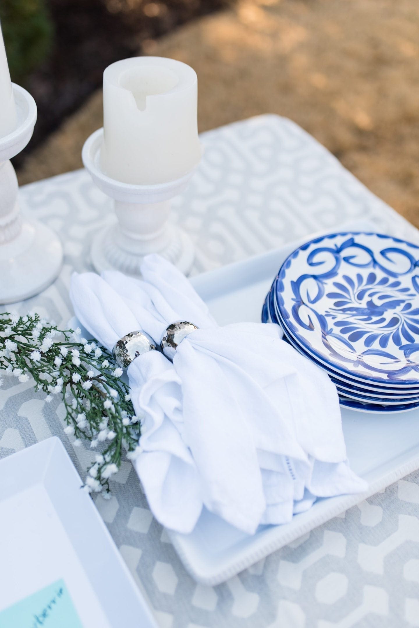 Easy and simple party set up. All white and blue table setting with pretty blue and white plates, white linens and babies breath.