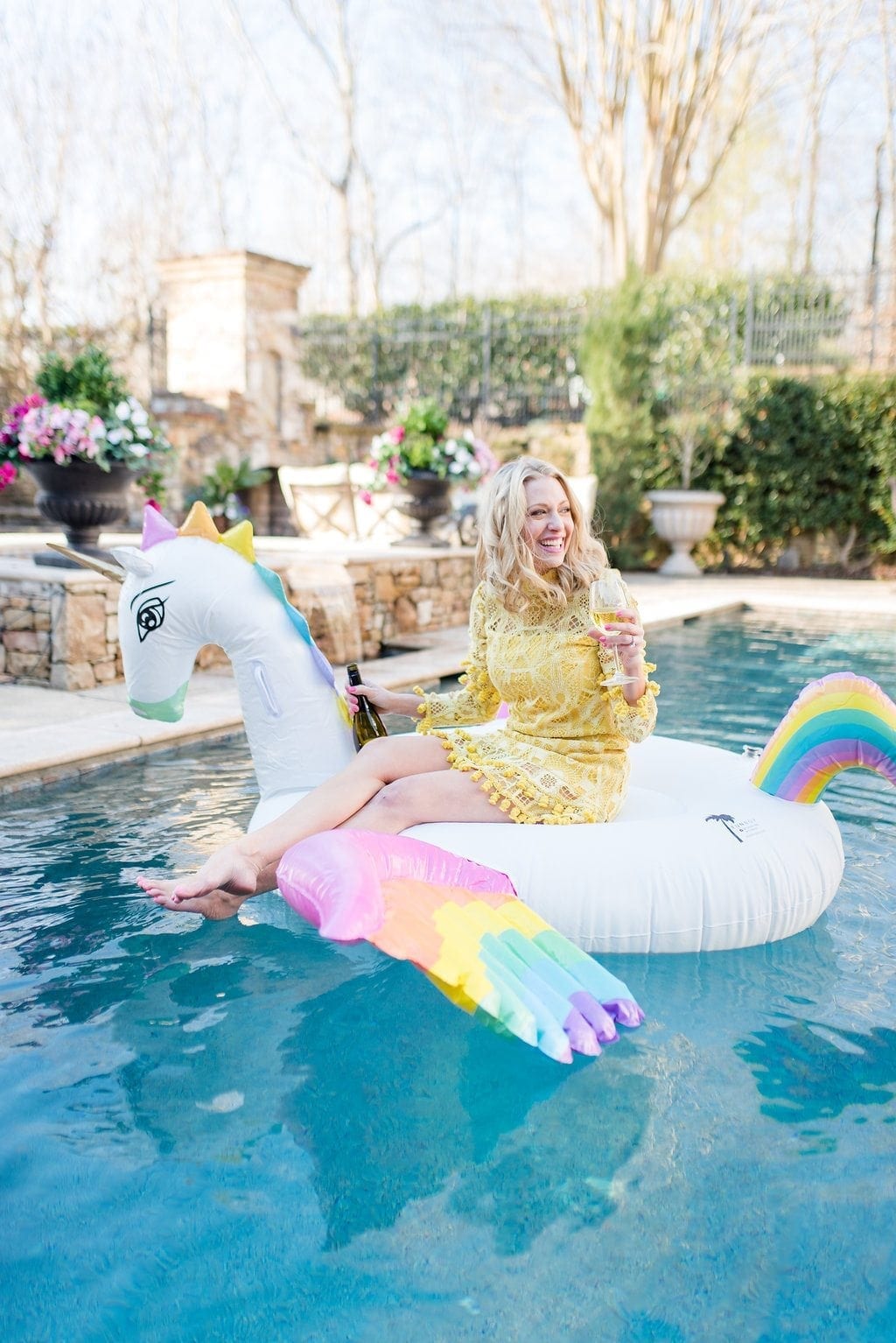 Atlanta lifestyle blogger, Kelly Page, for bluegraygal. Unicorn pool float and yellow Alexis Callisto Dress.