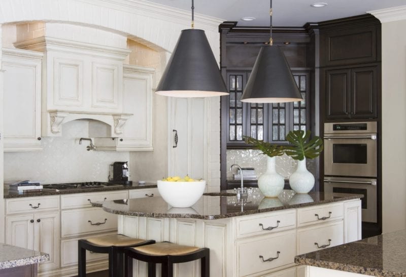 Painted brick kitchen and dark stained cabinetry. White and brown kitchen decor.