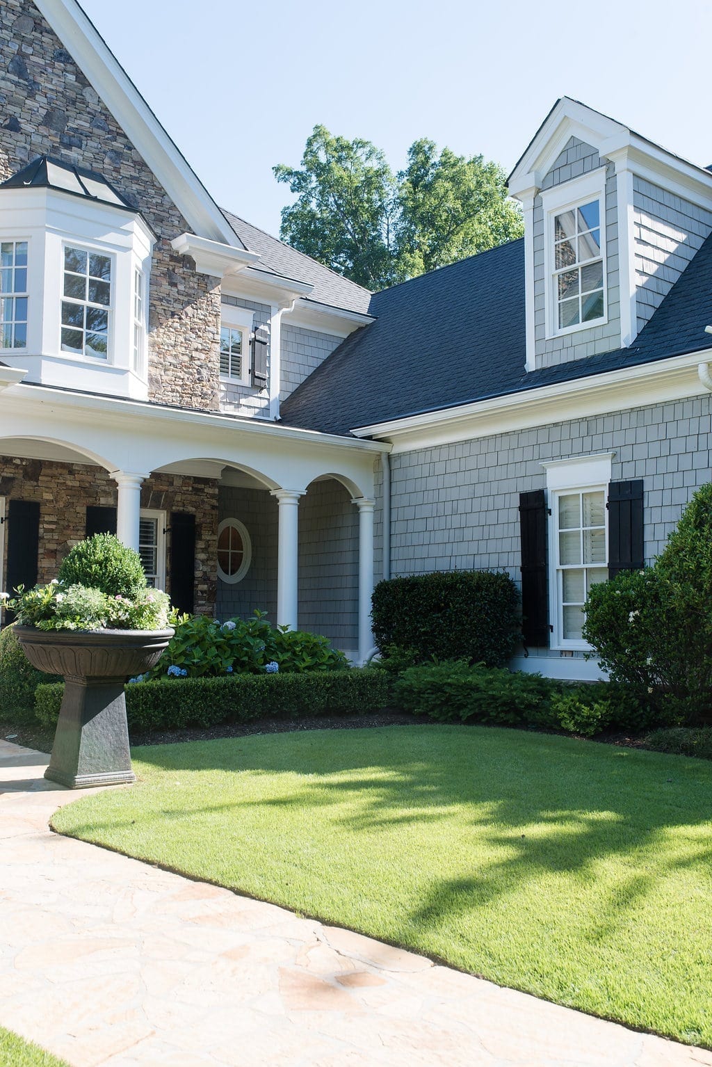 Sherwin Williams Tricorn Black SW 6258 is used on the shutters with Dorian Gray cedar siding and stacked stone on this Atlanta, Georgia home.