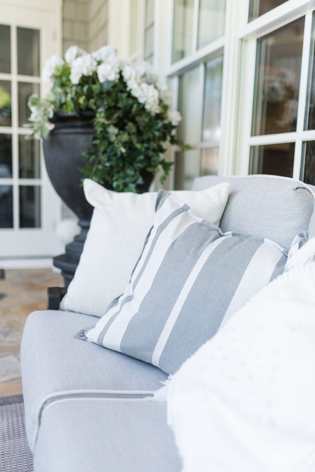 Gray outdoor throw pillows. Gray and white stripes. How to decorate outside.