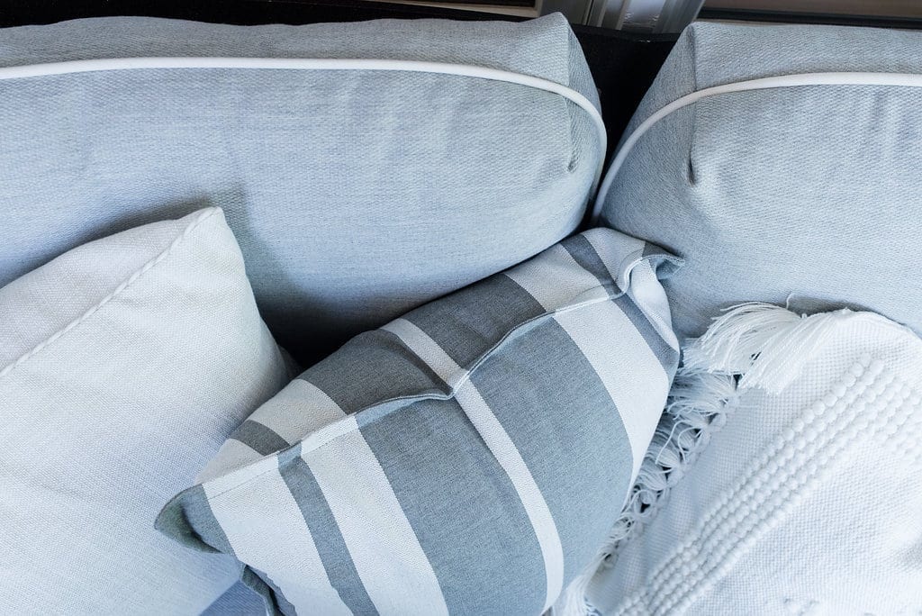 Serena and Lily pillows. Outdoor throw pillows in gray and white.