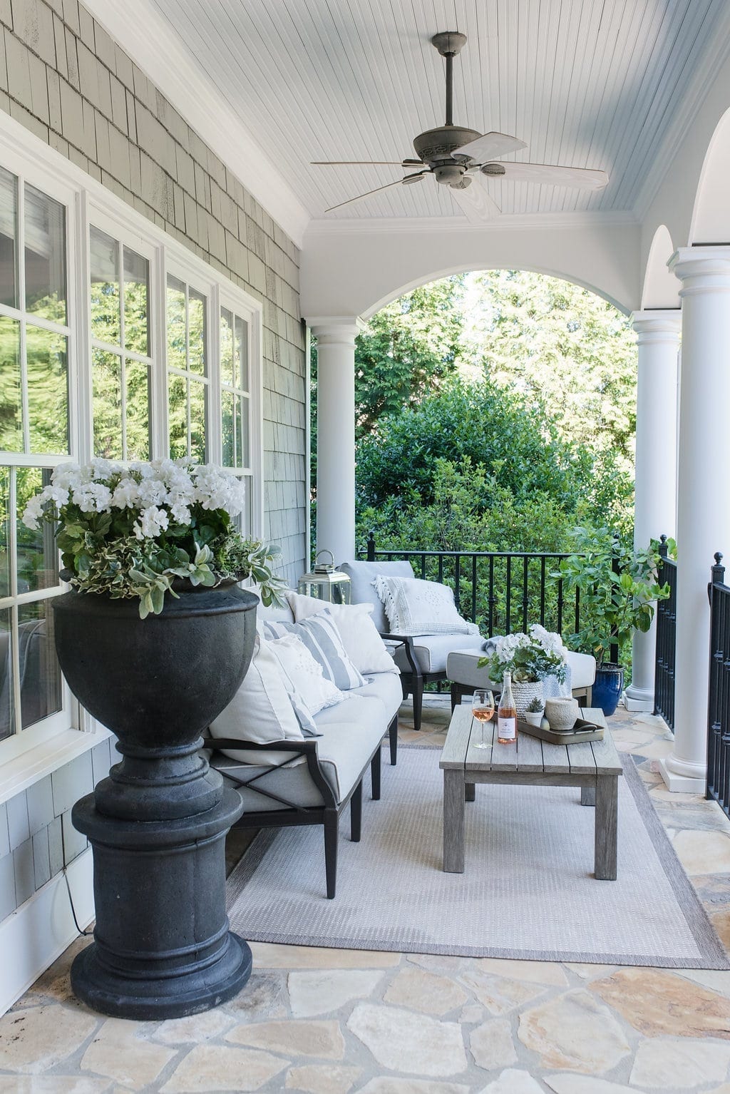 Woodard Furniture patio set. Gray and white outdoor furniture in balcony.
