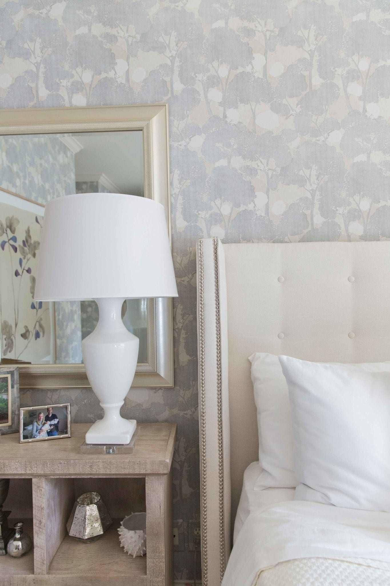 Purple and ivory bedroom design. Ivory headboard and white table lamps. Soothing bedroom.