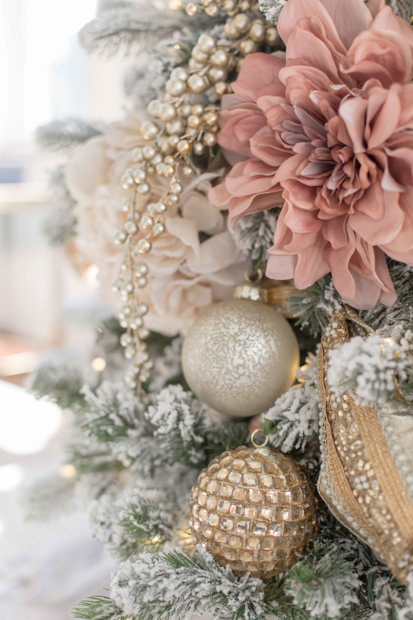 Pink and ivory decorated tree with gold ornament decor accents.