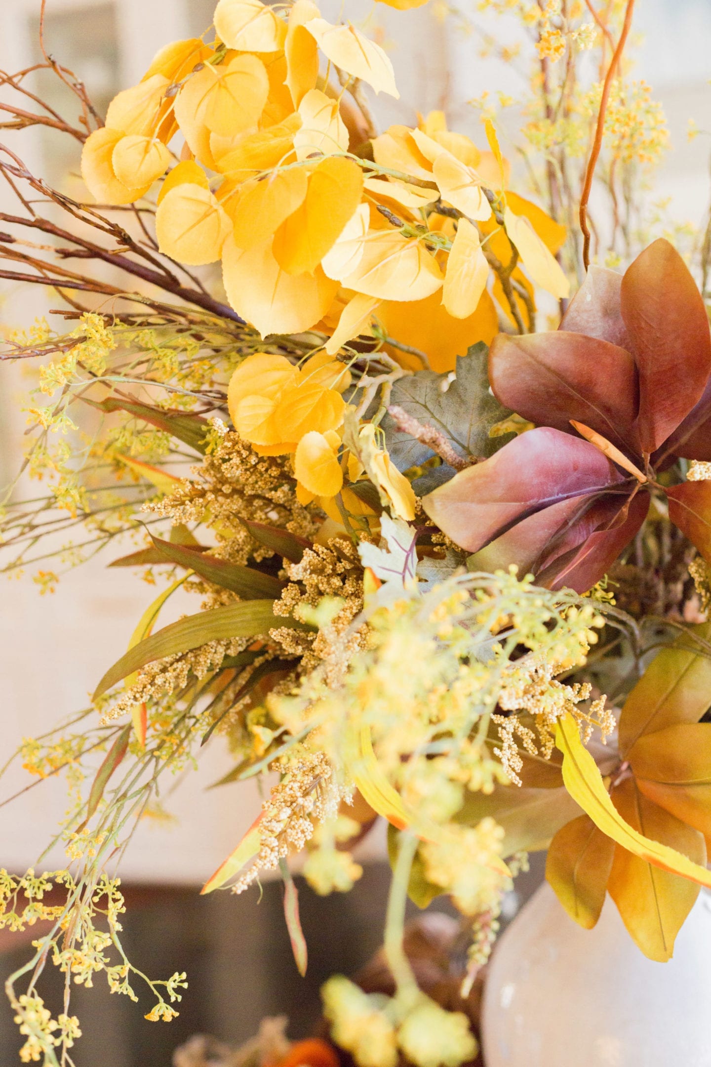 Thanksgiving Tablescape with yellow flowers and gold heather.