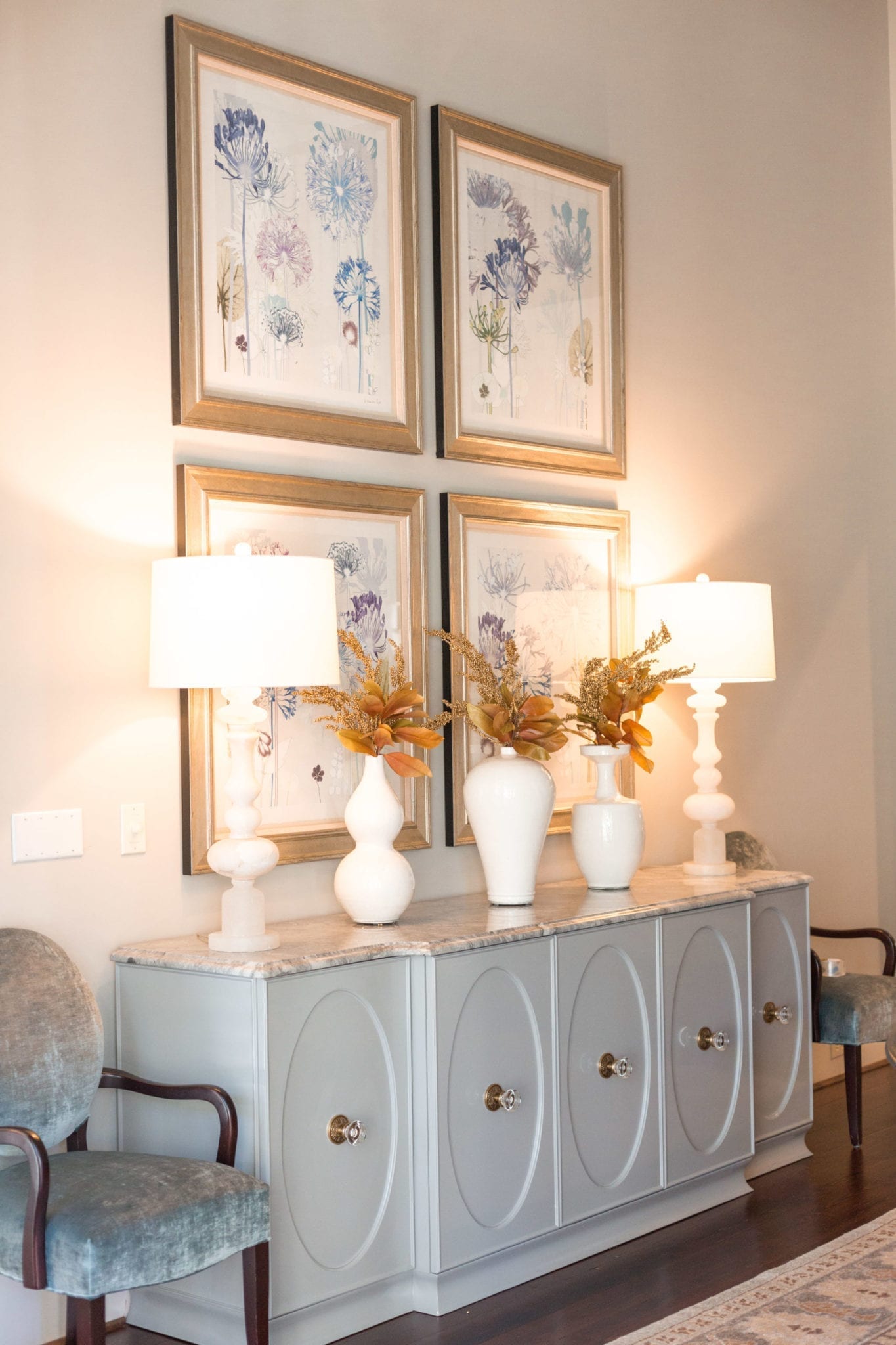 Dining room buffet console. Modern buffet with a little bit of white vases and fall leaves.