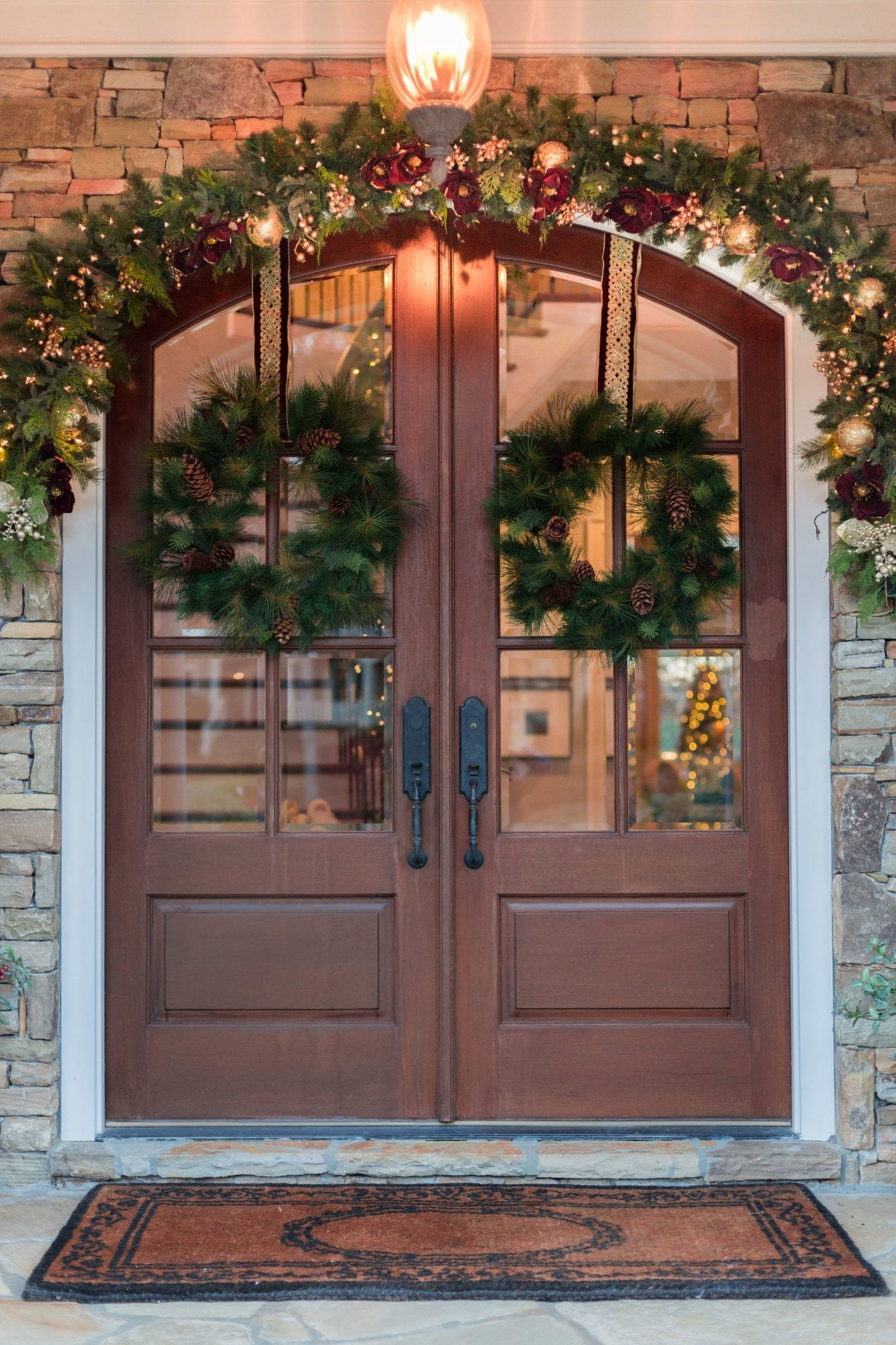 How to Hang Garland on Stone Outside. Front door holiday decorating with wreaths and garland.