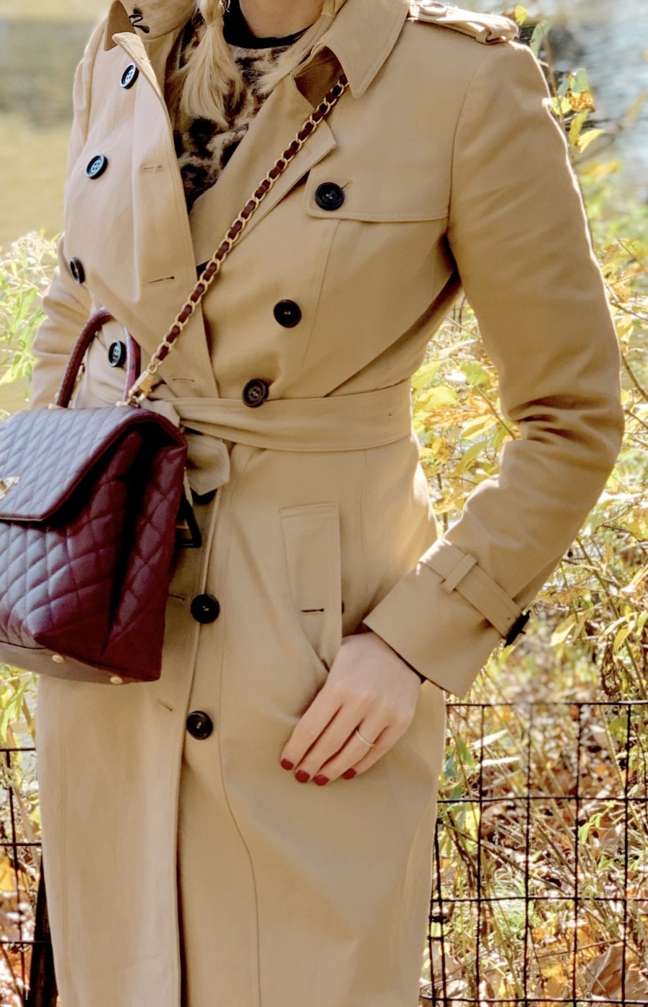 A Classic Trench coat from Burberry and Fall 2019 Chanel handbag in burgundy.