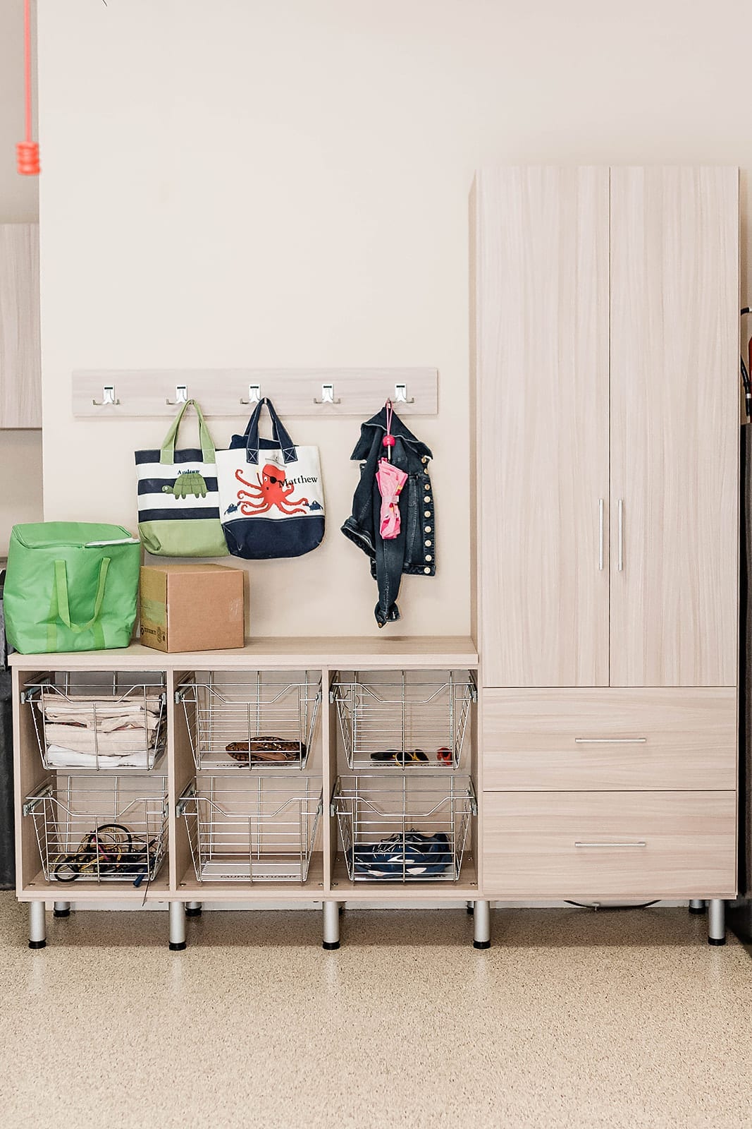 Garage Cabinet Ideas - adding a counter top and baskets to keep things easy to find in the garage for kid stuff.