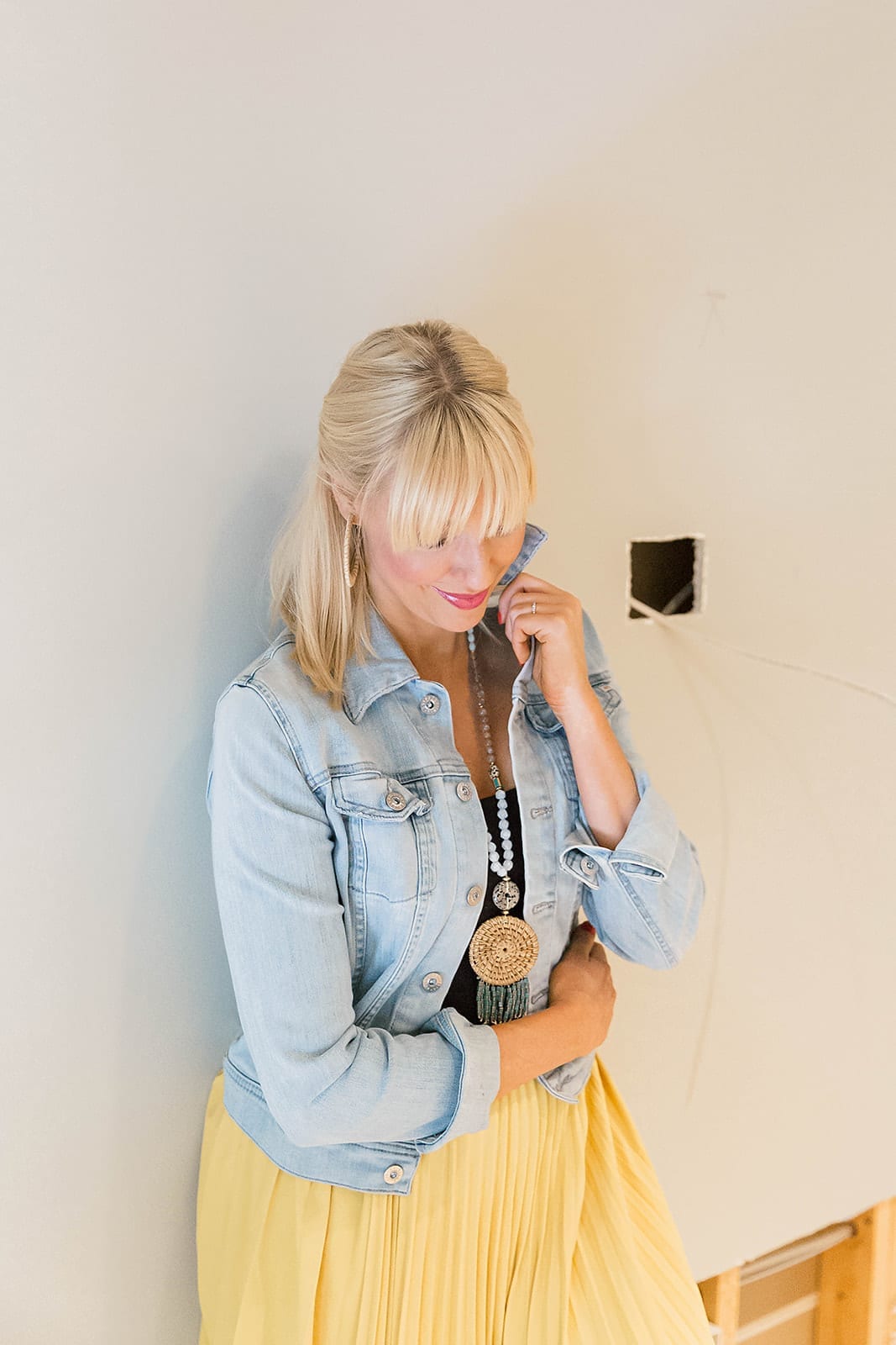AG Jean Jacket with bright yellow skirt and blue long layered statement Anthropologie necklace. Fringe bangs hairstyle.