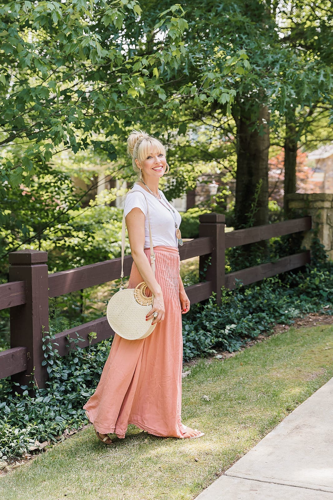 Summer Skirts in orange color. Beautiful button long skirt with slit that's lined.Styled with a straw handbag and top. knot.