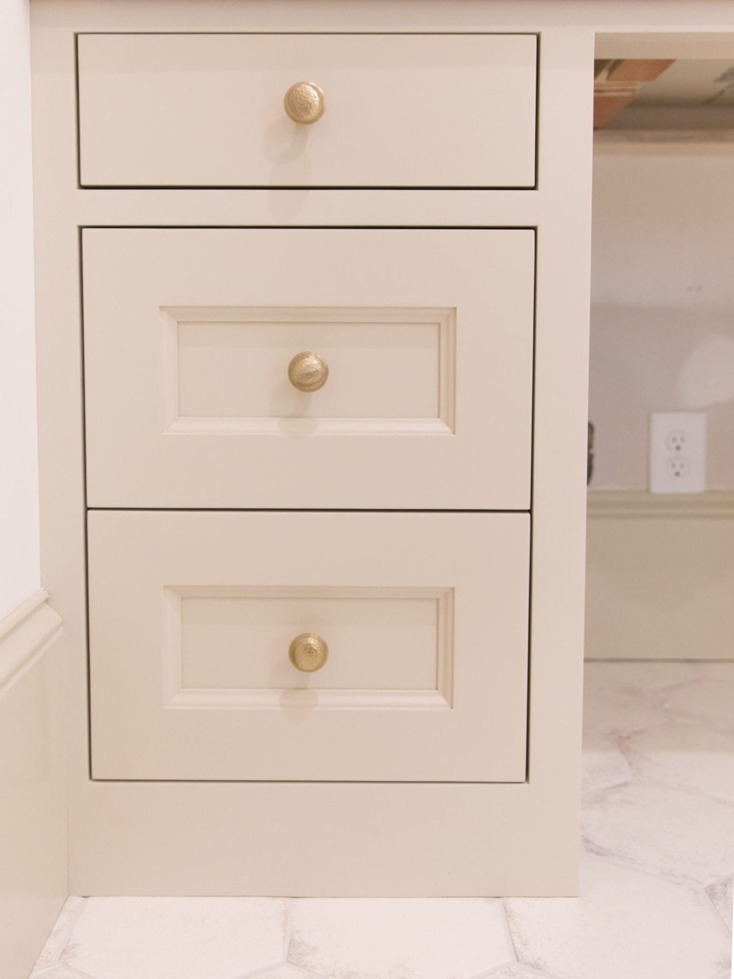 Hammered Hardware in bronze gold with Sherwin Williams Accessible Beige painted cabinets.