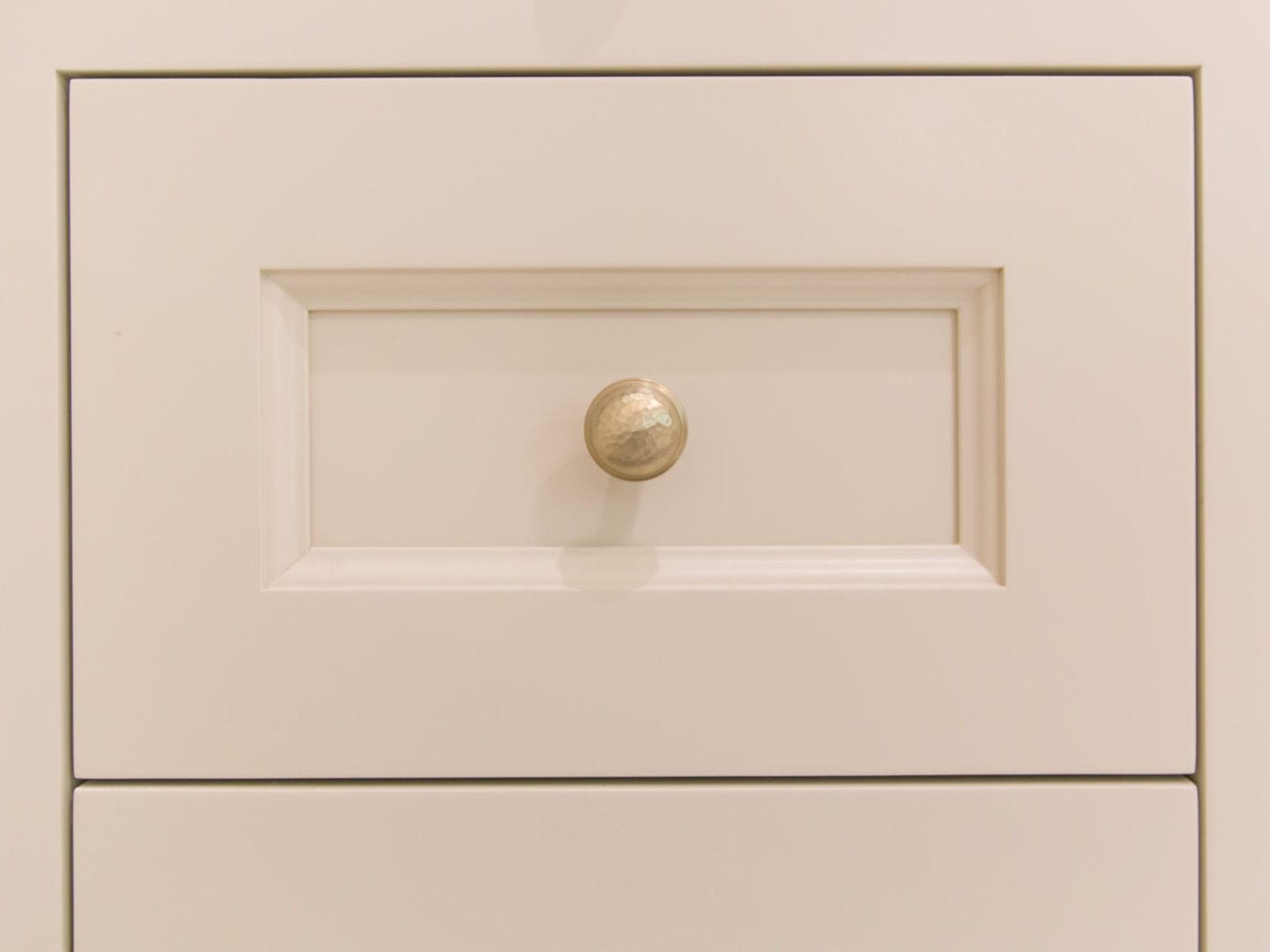 Hammered Hardware in bronze gold with Sherwin Williams Accessible Beige painted cabinets.