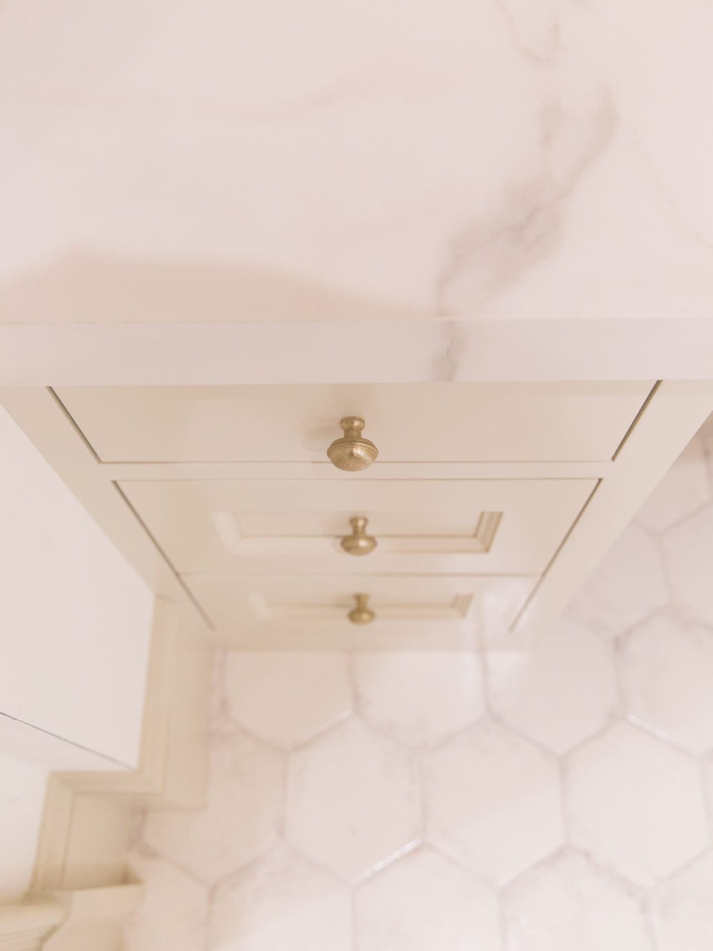 Hammered Hardware in bronze gold with Sherwin Williams Accessible Beige painted cabinets.